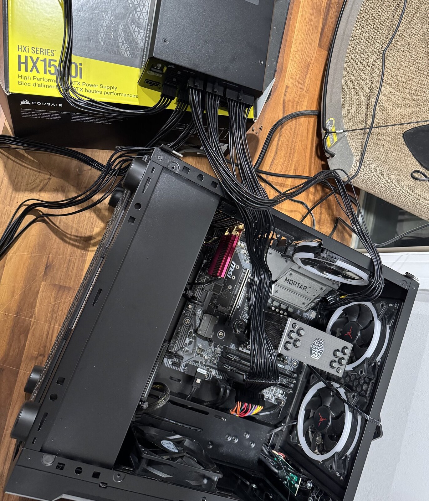 The 1500W supply on its box feeding the open case — the 3090 slot still empty